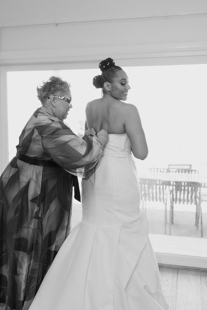 Two brides welcoming guests at reception, intimate wedding at Halyard SoundView Greenport New York, photographed by Morina Photography